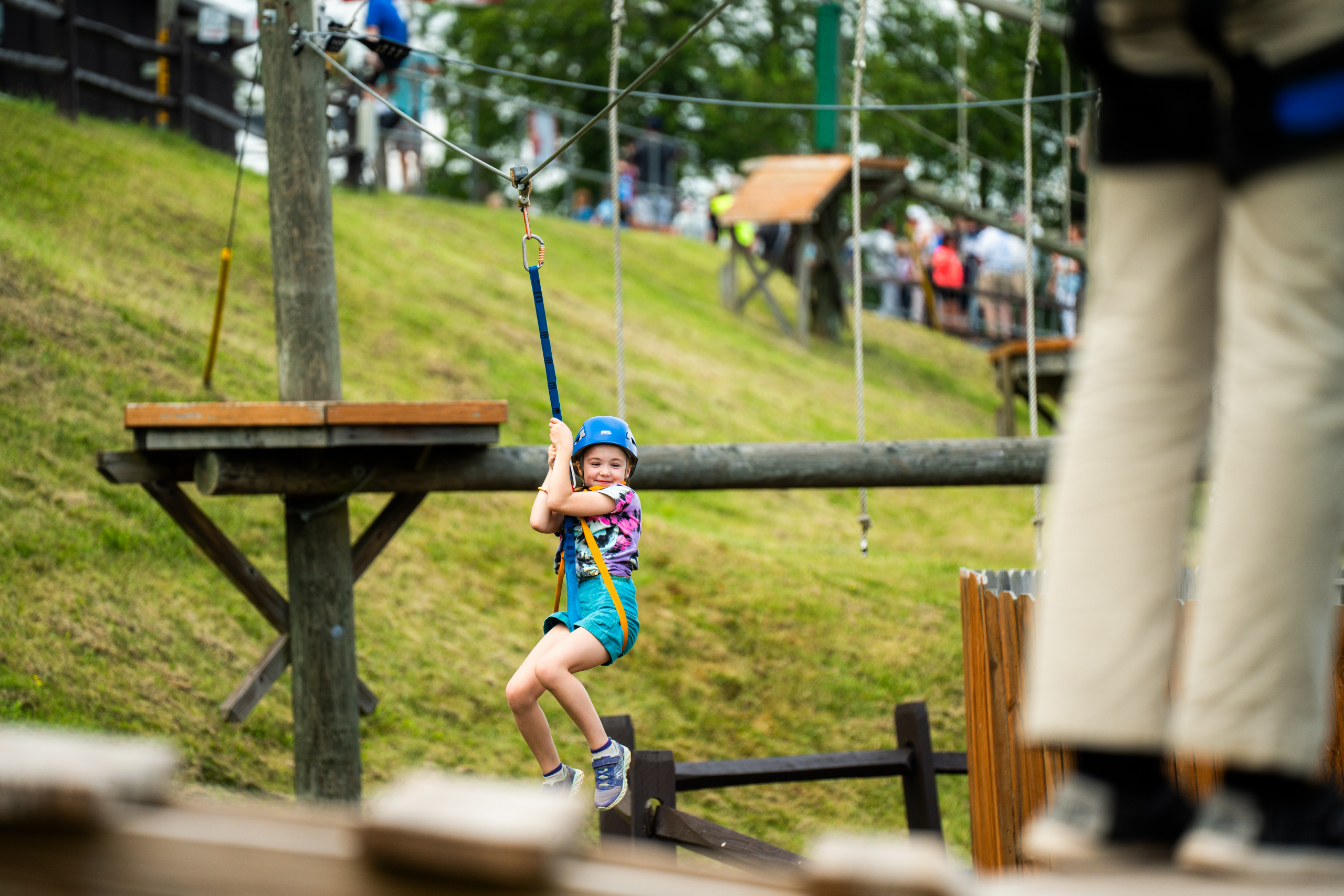 A young girl taking part in the Chipmunk Challenge Course at the Wisp Resort Mountain Park.